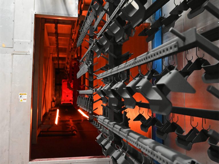 parts inside a tunnel curing oven at curing temperature